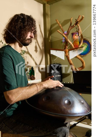 Relaxed performance featuring handpan and tranquil surroundings Relaxed performance featuring handpan and tranquil surroundings 139667774