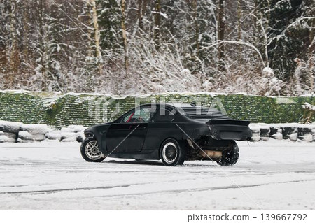Sportscar with sparks moves through frosted woodland environment 139667792