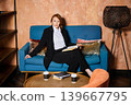Confident female professional resting in stylish lounge 139667795
