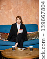 Recruiter sitting comfortably reviewing documents and notes 139667804