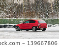 Automobile shows damage while negotiating snowcovered sharp turn 139667806