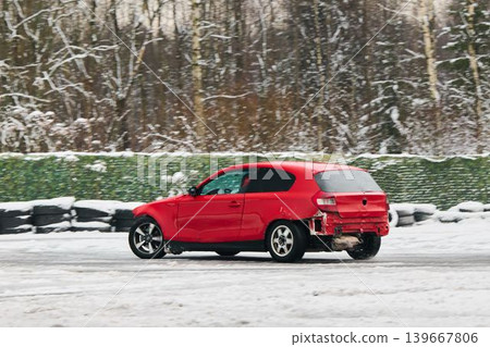 Automobile shows damage while negotiating snowcovered sharp turn Automobile shows damage while negotiating snowcovered sharp turn 139667806