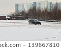 Sedan leaps over icy spray. Vehicle slices through frosty white spray 139667810