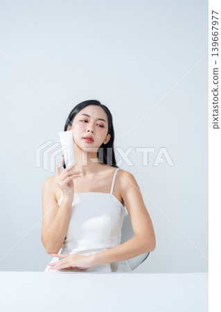 Asian woman holding product isolated on white background for promotion advertising. Asian woman holding product isolated on white background for promotion advertising. 139667977