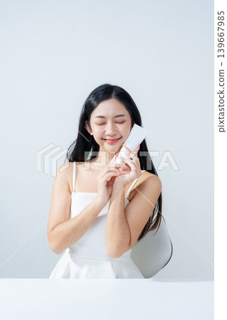 Asian woman holding product isolated on white background for promotion advertising. Asian woman holding product isolated on white background for promotion advertising. 139667985