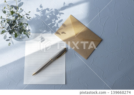 A natural letter image featuring a blue background, stationery, an envelope, and a pen. A natural letter image featuring a blue background, stationery, an envelope, and a pen. 139668274