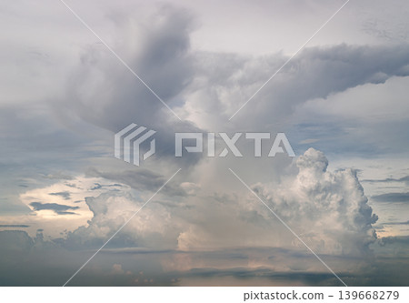 Majestic Cumulonimbus clouds dominate the horizon like rising ivory fortresses. Their billowing, cauliflower-like peaks surge upward, catching the soft glow of a hidden sun. Majestic Cumulonimbus clouds dominate the horizon like rising ivory fortresses. Their billowing, cauliflower-like peaks surge upward, catching the soft glow of a hidden sun. 139668279