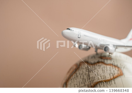 Airplane on globe close up, international travel tourism transportation and global destination concept Airplane on globe close up, international travel tourism transportation and global destination concept 139668348