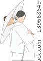 A bride in a white kimono and carrying a traditional Japanese umbrella. 139668649