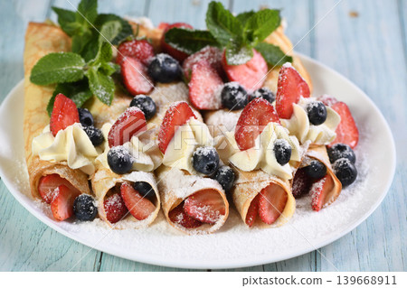 French crepes with cream and berries French crepes with cream and berries 139668911