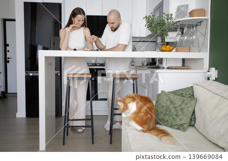 Cheerful woman and man playing chess at home Cheerful woman and man playing chess at home 139669084