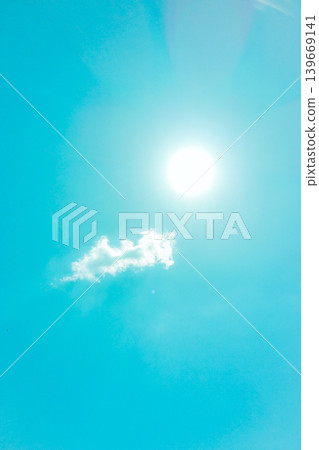 The sun shines brightly in the clear blue sky, and soft white clouds float gently in the air. The sun shines brightly in the clear blue sky, and soft white clouds float gently in the air. 139669141