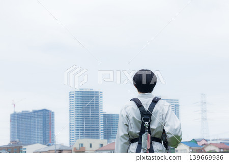 Workers wearing full body harnesses Workers wearing full body harnesses 139669986