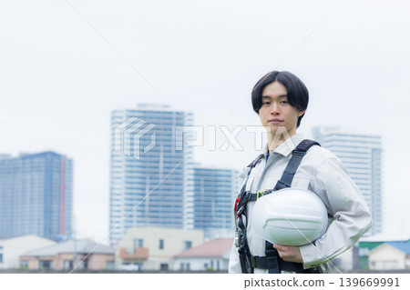 Workers wearing full body harnesses Workers wearing full body harnesses 139669991