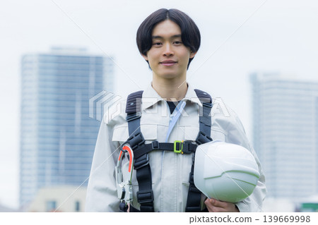 Workers wearing full body harnesses Workers wearing full body harnesses 139669998