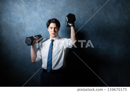 A businessman with a dumbbell A businessman with a dumbbell 139670175