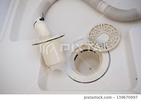 I'm cleaning the washing machine drain with detergent. I'm cleaning the washing machine drain with detergent. 139670997