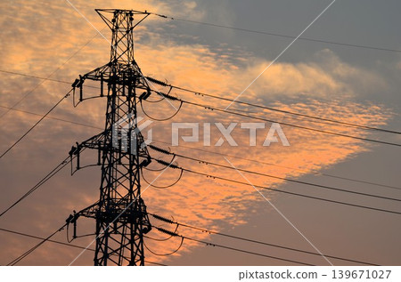A cloudy sunset and a power transmission tower A cloudy sunset and a power transmission tower 139671027