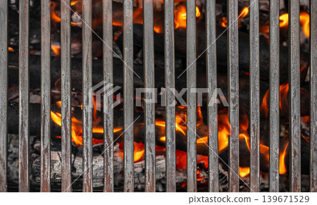 Grill grate with fire and hot charcoal closeup Grill grate with fire and hot charcoal closeup 139671529