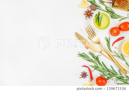 Cooking ingredients with golden cutlery and herbs on white background Cooking ingredients with golden cutlery and herbs on white background 139671536