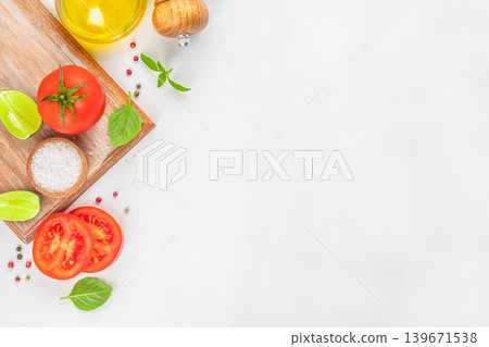 Tomato basil lime and olive oil cooking ingredients on white background Tomato basil lime and olive oil cooking ingredients on white background 139671538