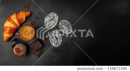 Fresh breakfast with croissant, coffee and chocolate spread on dark background with copy space, top view flat lay 139671596