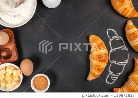 Fresh croissants with baking ingredients and chalk sketch on black background, top view bakery banner Fresh croissants with baking ingredients and chalk sketch on black background, top view bakery banner 139671622