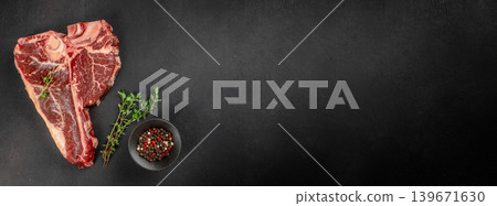 Raw tomahawk beef steak with pepper and thyme on black background with copy space for premium meat advertising Raw tomahawk beef steak with pepper and thyme on black background with copy space for premium meat advertising 139671630