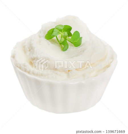 Cream cheese spread in white bowl with microgreens isolated on white background 139671669