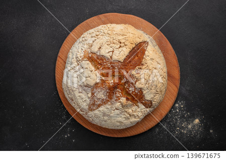 Artisan sourdough bread loaf on dark rustic background top view with copy space for bakery branding 139671675