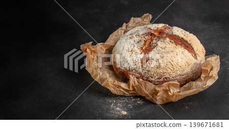 Rustic artisan sourdough bread on dark background with copy space for bakery advertising Rustic artisan sourdough bread on dark background with copy space for bakery advertising 139671681