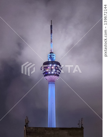 Menara KL Tower Illuminated at Night Against Cloudy Sky in Kuala Lumpur, Malaysia Menara KL Tower Illuminated at Night Against Cloudy Sky in Kuala Lumpur, Malaysia 139672144