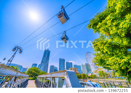 Yokohama Cityscape, Japan: A view of the lush green railway track and Yokohama Landmark Tower from Canal Park in front of Canal Park Station. Yokohama Cityscape, Japan: A view of the lush green railway track and Yokohama Landmark Tower from Canal Park in front of Canal Park Station. 139672255