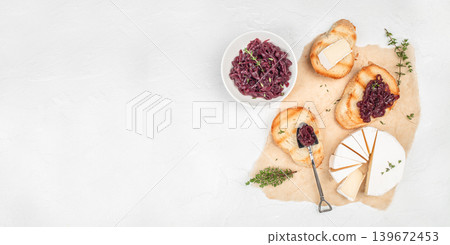 Gourmet appetizer with toasted bread and caramelized onion jam and cheese on light background with copy space Gourmet appetizer with toasted bread and caramelized onion jam and cheese on light background with copy space 139672453