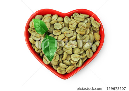 Green coffee beans in ceramic bowl isolated on white background. Top view Green coffee beans in ceramic bowl isolated on white background. Top view 139672507