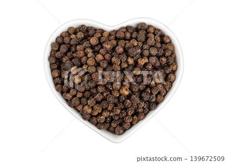 Black peppercorns or pepper in a ceramic bowl isolated on a white background. Top view. Flat lay Black peppercorns or pepper in a ceramic bowl isolated on a white background. Top view. Flat lay 139672509