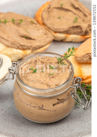 Liver pate in glass jar with toasted bread and herbs close up food composition 139672552