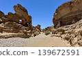 A rocky canyon landscape viewed from the valley below. 139672591