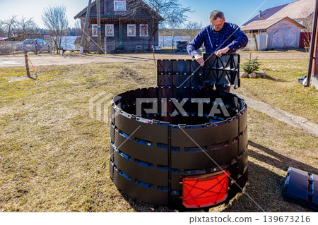 Modular assembly of panel compost bin, gardener snap together segmented during installing modular composter. 139673216