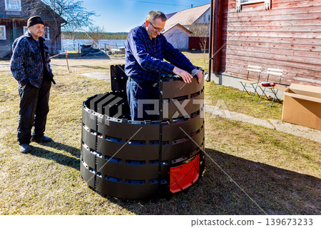 Modular compost bin is interlocking design of slot together construction, farmer tool free modular assembly composter near country house. Modular compost bin is interlocking design of slot together construction, farmer tool free modular assembly composter near country house. 139673233