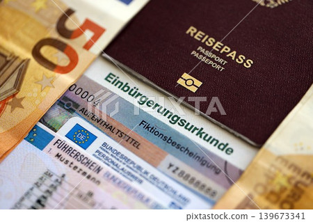 German passport and an identity card on an official naturalization certificate German passport and an identity card on an official naturalization certificate 139673341