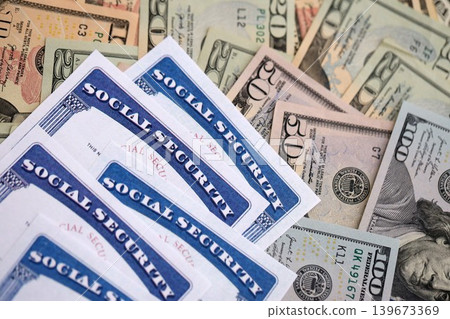 Social security number cards on many US dollar money bills 139673369