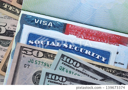 Social security number and visa on passport page with US dollar money bills Social security number and visa on passport page with US dollar money bills 139673374