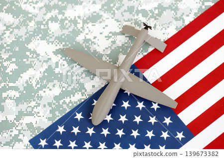 Drone unmanned autonomous technology of espionage and strikes on the enemy. Toy uav drone on flag Drone unmanned autonomous technology of espionage and strikes on the enemy. Toy uav drone on flag 139673382