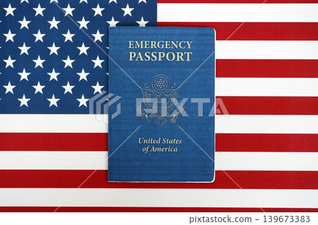 United States emergency passport book on US flag close up. Travel document on official banner United States emergency passport book on US flag close up. Travel document on official banner 139673383