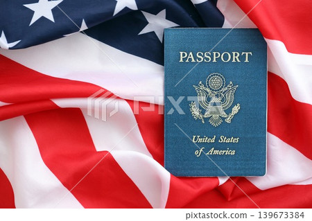 United States passport book on US flag close up. Travel document on official banner United States passport book on US flag close up. Travel document on official banner 139673384