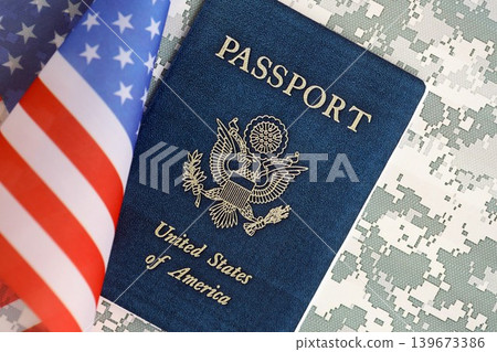 United States passport book with US flag on camouflage uniform close up United States passport book with US flag on camouflage uniform close up 139673386