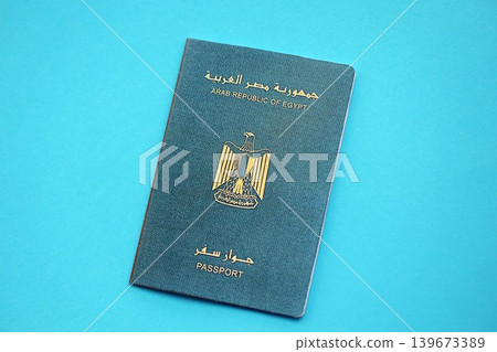 Egyptian passport book on light blue paper background close up. Travel document Egyptian passport book on light blue paper background close up. Travel document 139673389