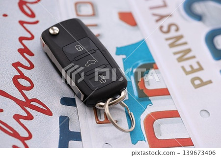 Remote control car keys on US license plates with various state names. Driving in United States Remote control car keys on US license plates with various state names. Driving in United States 139673406