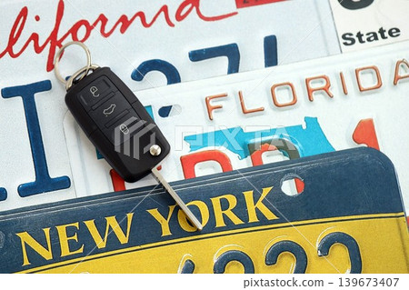 Remote control car keys on US license plates with state names. Driving in United States 139673407
